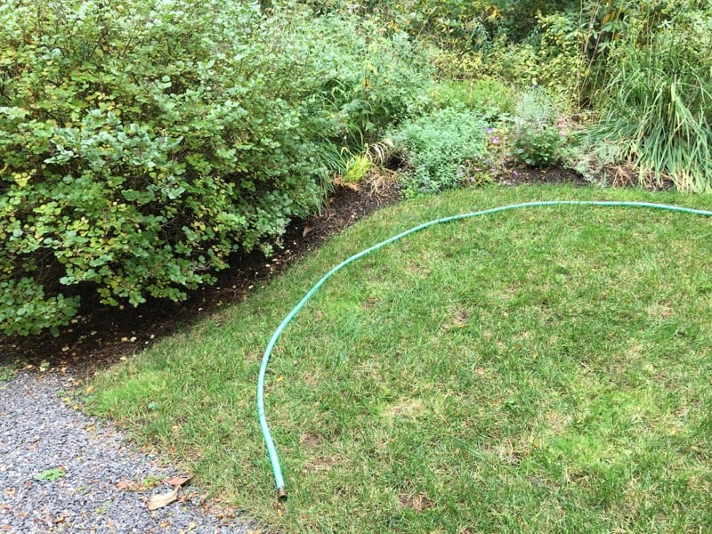 using-a-hose-to-edge-a-garden.jpg
